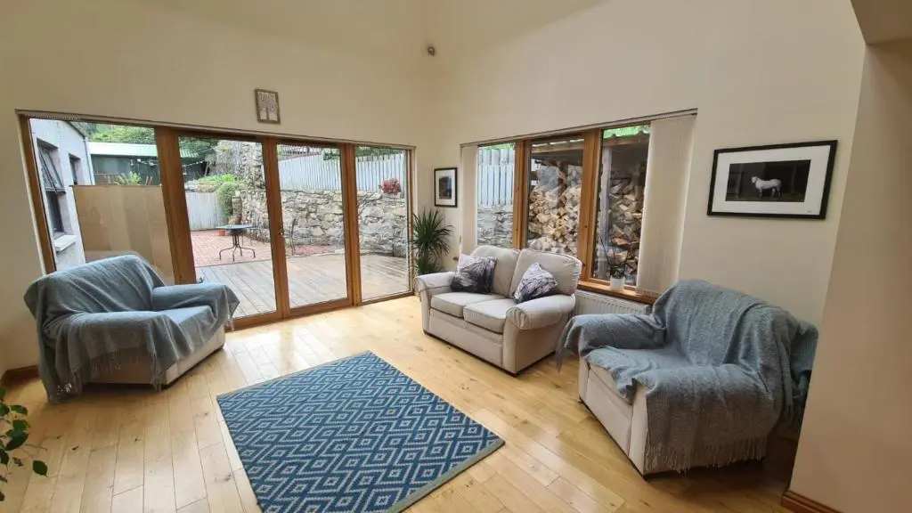 a living room with two chairs and a couch at Milne's Brae, cosy, comfortable and centrally located in beautiful Braemar in Braemar