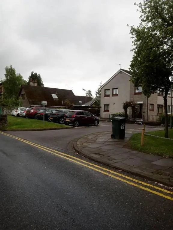 a street with cars parked on the side of the road at 3-Bed House Sleeps 5 5 min walk from City Centre in Inverness