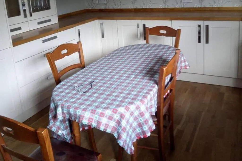 a table in a kitchen with a checkered table cloth at 3-Bed House Sleeps 5 5 min walk from City Centre in Inverness