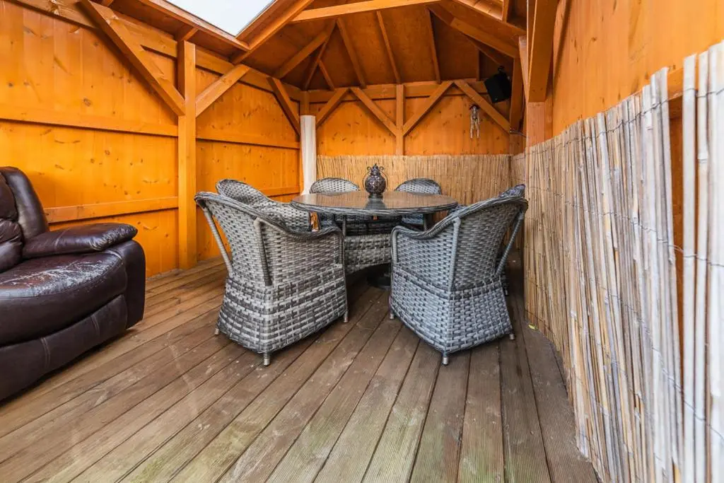 a patio with a table and chairs and a couch at Willa , Cosy house in Inverness in Inverness