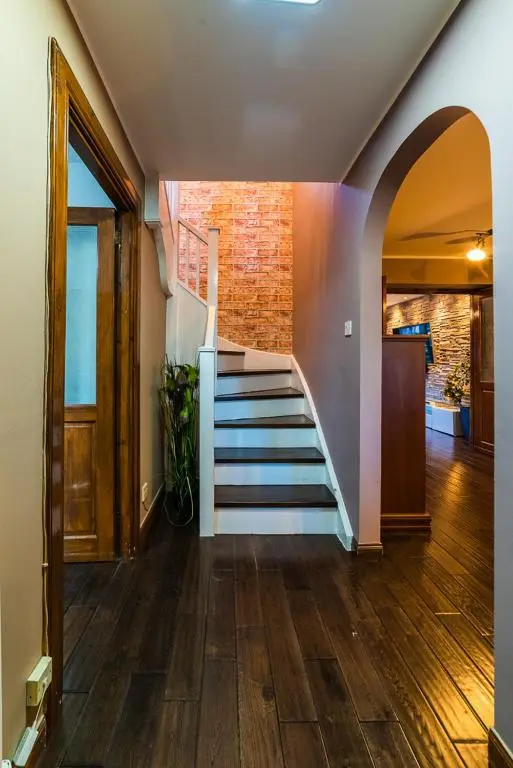 a hallway with stairs and a brick wall at Willa , Cosy house in Inverness in Inverness