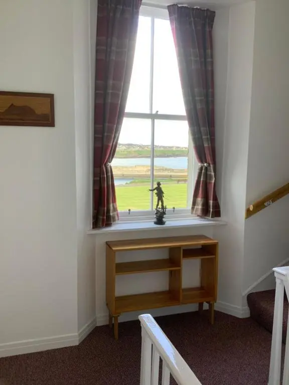 a room with a window with a statue in front of it at Harbour View in Wick
