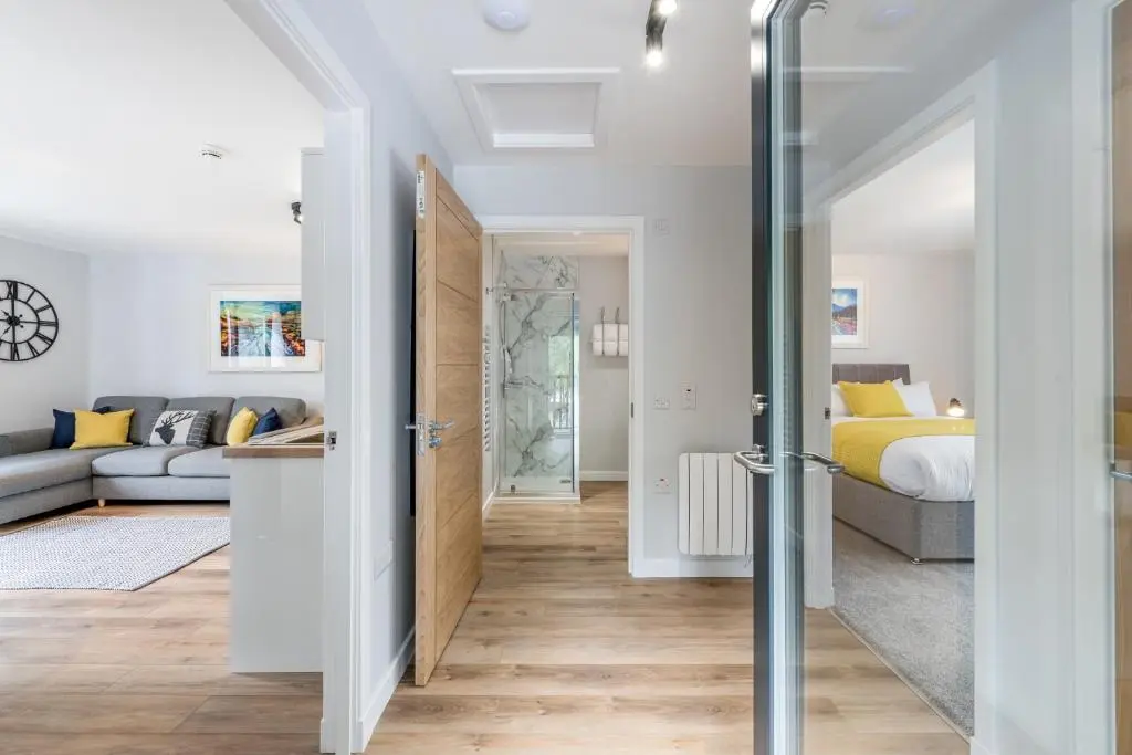 a bedroom and a living room with a bed at High Range Holiday Apartments in Aviemore