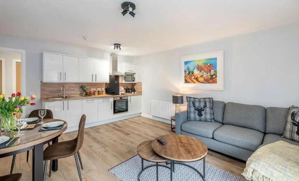 a living room with a couch and a table at High Range Holiday Apartments in Aviemore