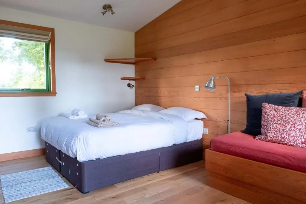 a bedroom with two beds and a window at Marcassie Farm Lodges - Oak Studio - Accessible in Forres