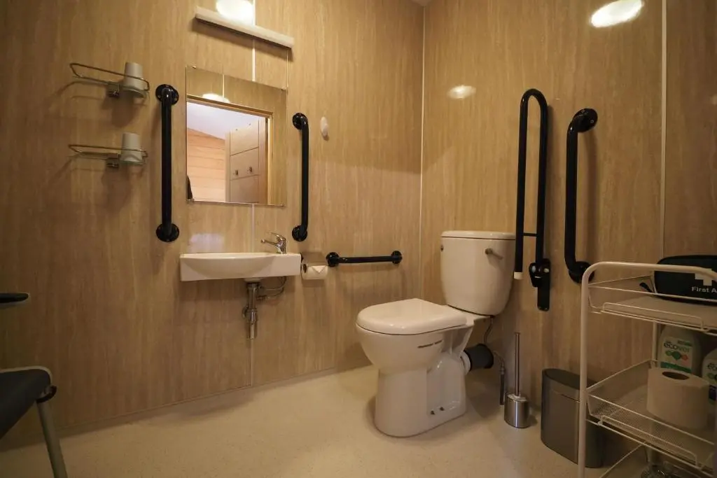 a bathroom with a toilet and a sink at Marcassie Farm Lodges - Oak Studio - Accessible in Forres