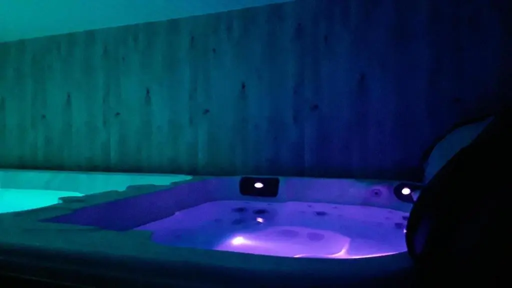 a purple bath tub in a dark room at Wester Curr Cottage - Luxury 5-Star Cottage with Private Pool & Hot Tub in Grantown on Spey