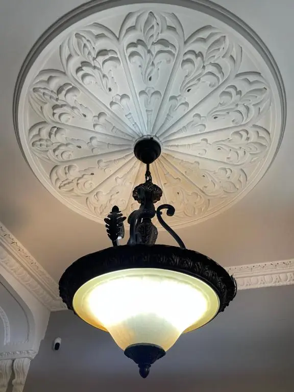 a chandelier hanging from a ceiling in a room at Shandwick House in Tain