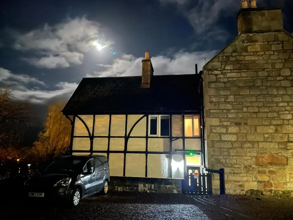 a car parked in front of a house at night at Shandwick House in Tain