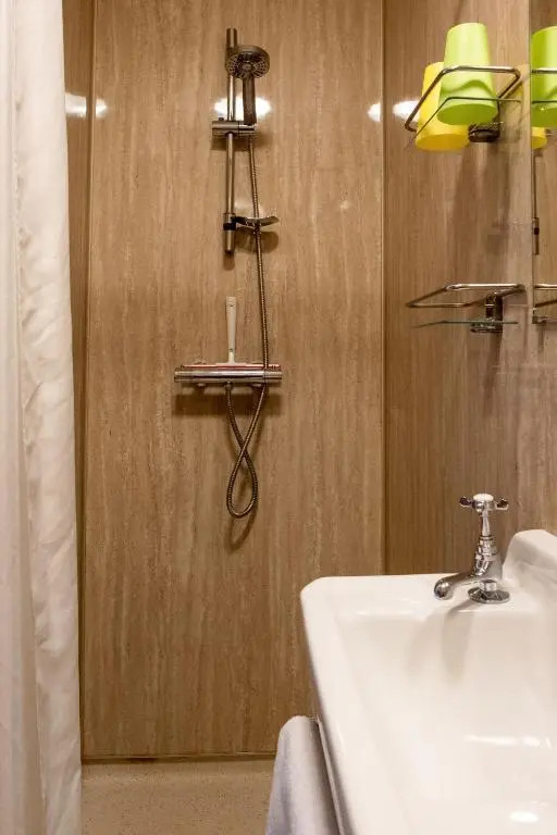 a bathroom with a sink and a mirror at Marcassie Farm Lodges - Blackthorn Studio in Forres