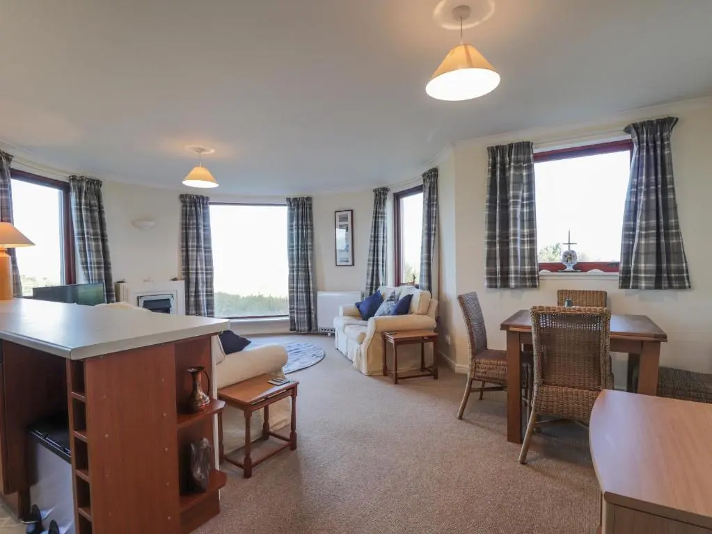 a living room with a couch and a table at Aurora View in Forres