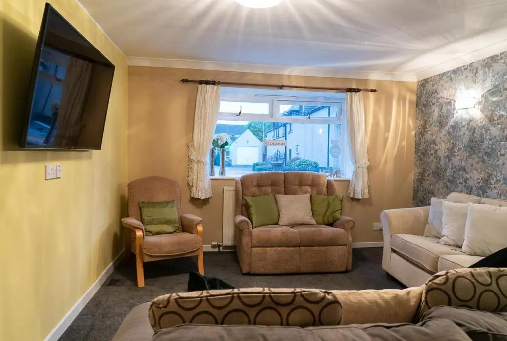 a living room with a couch and chairs and a window at Dunedin House -Contractors - Business Travellers in Huntly