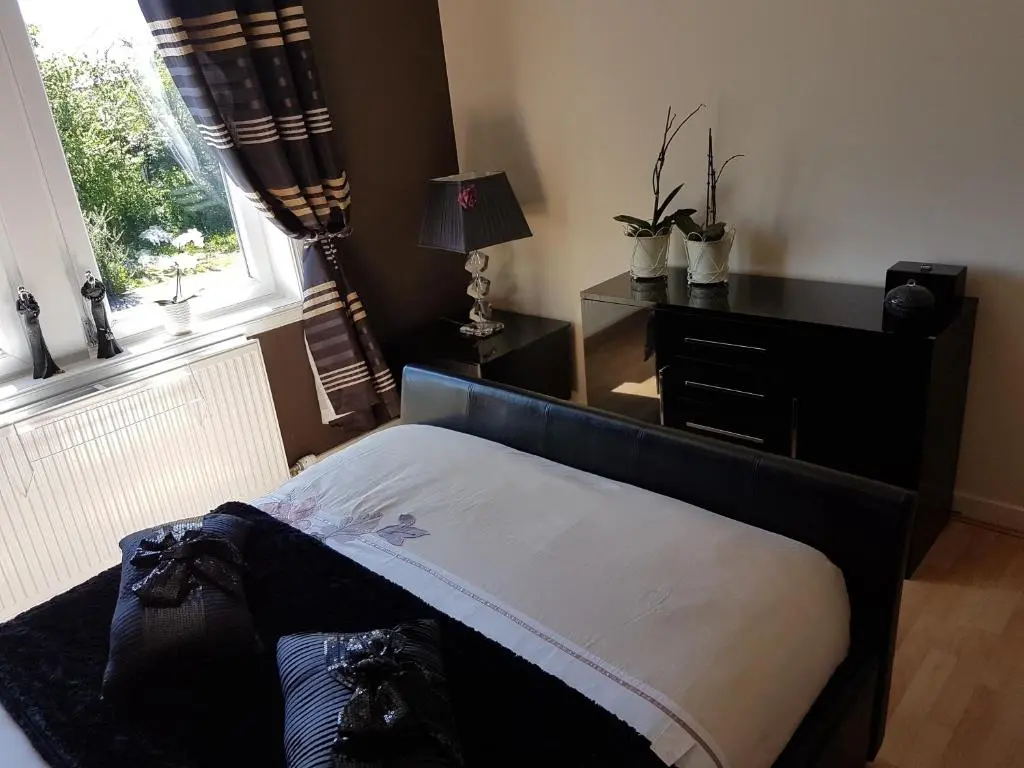a bedroom with a bed and a window at Spacious 2 double bedrooms house for a relaxing stay. in Inverness