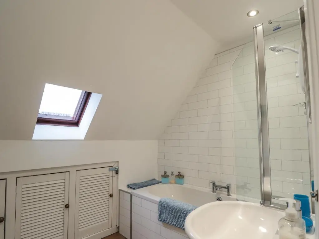 a bathroom with a sink and a bath tub at 3 Dunrobin Street in Tain