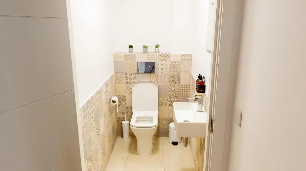 a small bathroom with a toilet and a sink at Alpine View - a cosy Aviemore House in Aviemore