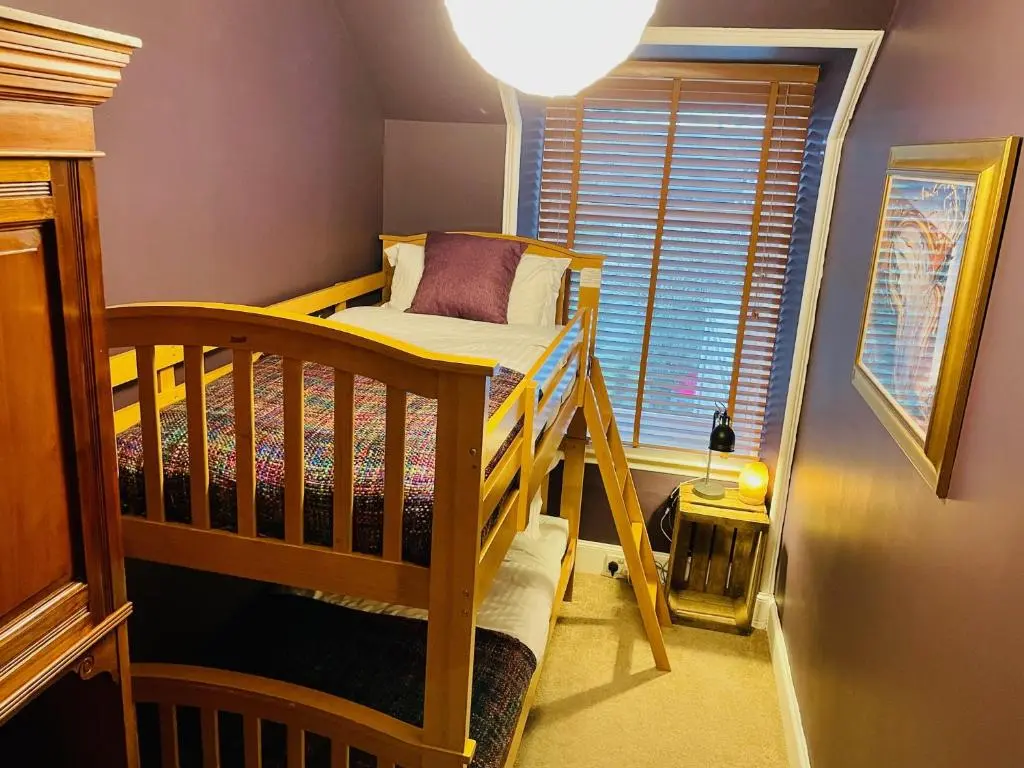 a small room with a bunk bed and a window at Ladies Lodge Inverness in Inverness