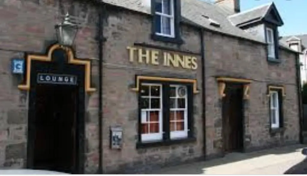 a brick building with a sign that reads the nines at Inverness city apartments - Innes in Inverness
