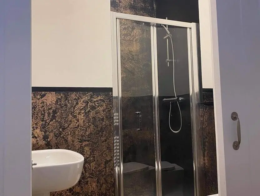 a bathroom with a shower and a sink at Butterfly Cottage in Grantown on Spey
