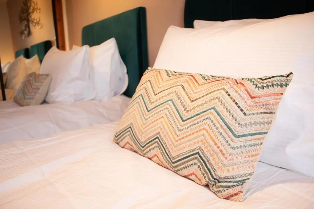 a pillow sitting on top of a bed at Burnside Pines in Aviemore