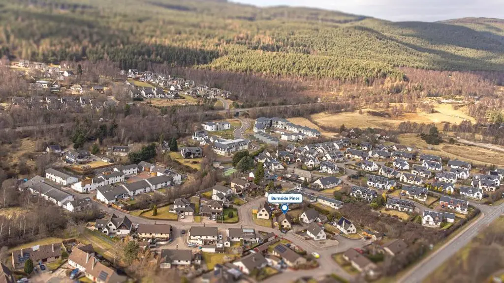 an aerial view of a small town in the mountains at Burnside Pines in Aviemore