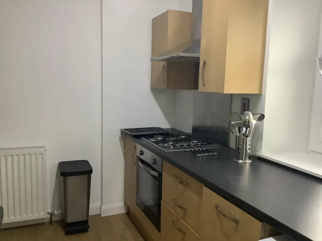 a kitchen with a stove and a counter top at 4 Stills Apartment in Rothes