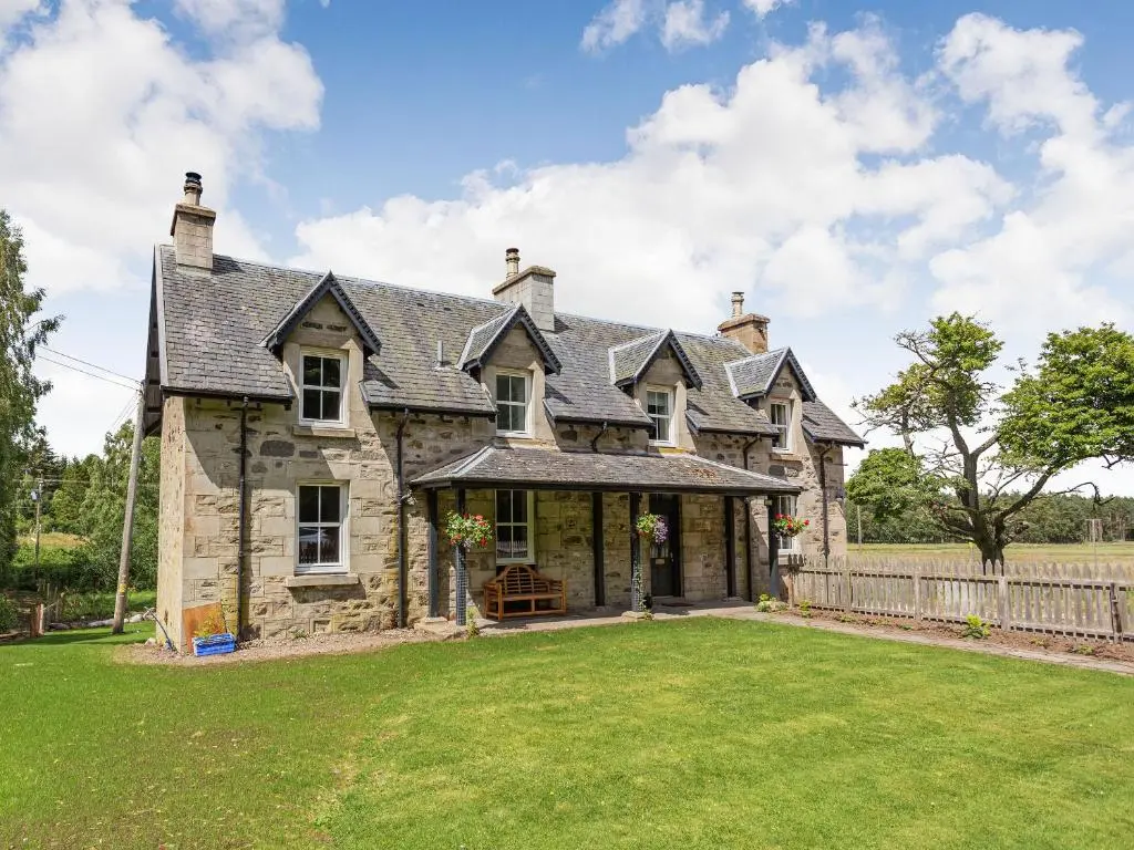 an old stone house with a large yard at New Cottage in Farr