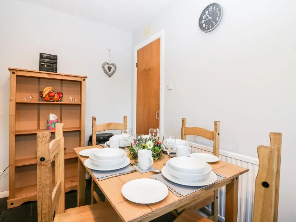 a dining room with a wooden table and chairs at 10 Annesley Park in Banchory