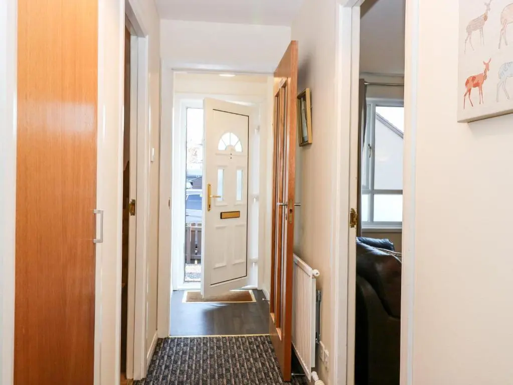 a hallway with a door leading into a room at 10 Annesley Park in Banchory