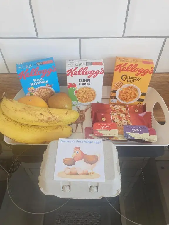 a shelf with some food and some cereal and bananas at Castle Shieling in Latheron