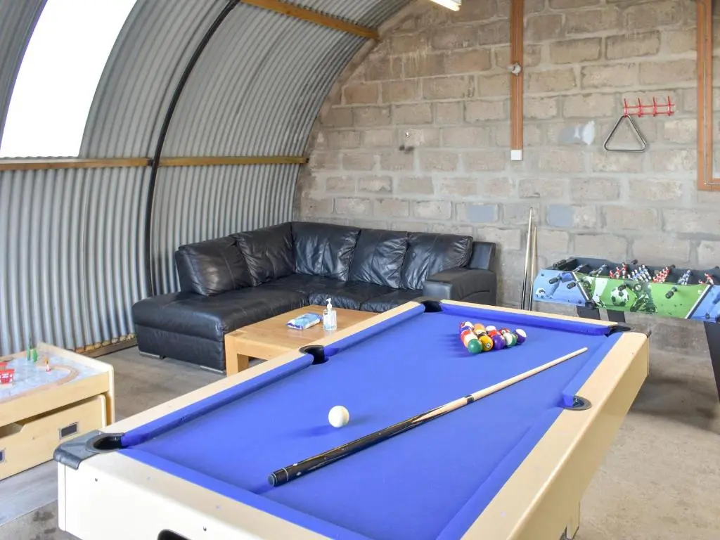 a living room with a pool table and a couch at Benwells Holiday Cottage in Maud