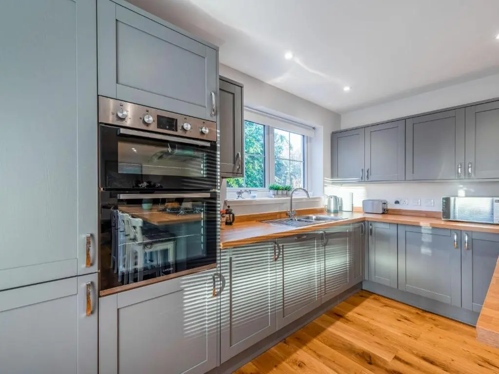 a kitchen with gray cabinets and a sink at Holiday Home Loch Ness House by Interhome in Drumnadrochit