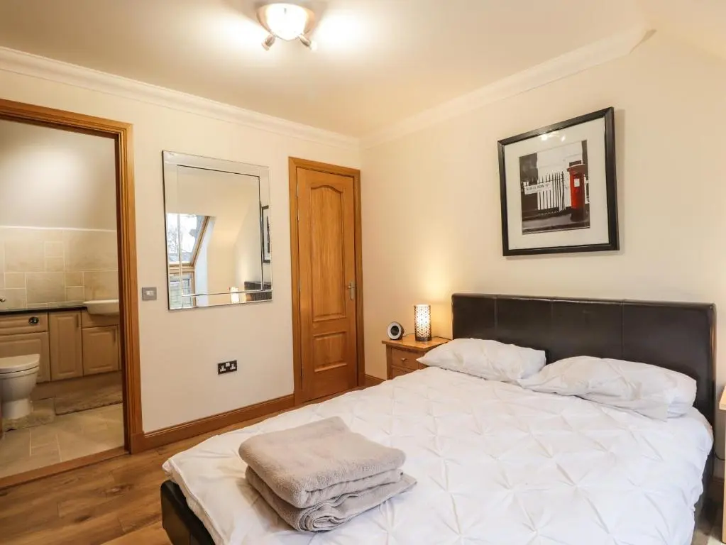 a bedroom with a bed with towels on it at 1 The Coach House in Elgin