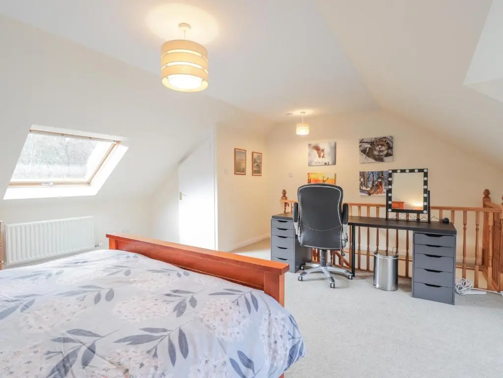 a bedroom with a bed and a desk and a chair at Iola in Inverness