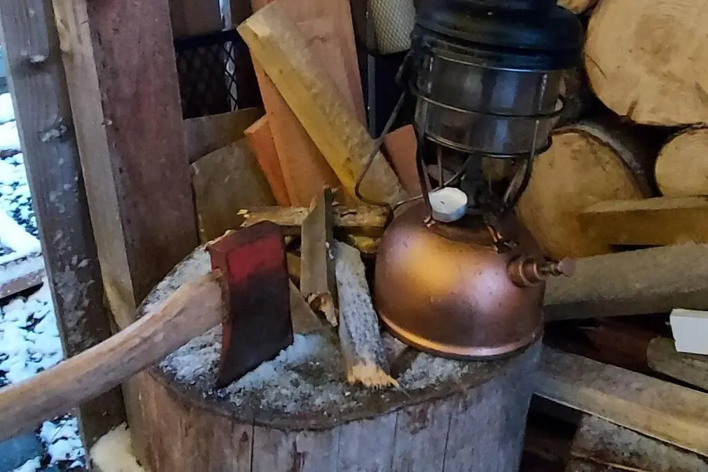 an old bell sitting on top of a mortar at Wee Blondie's Ski Cottage in Aviemore