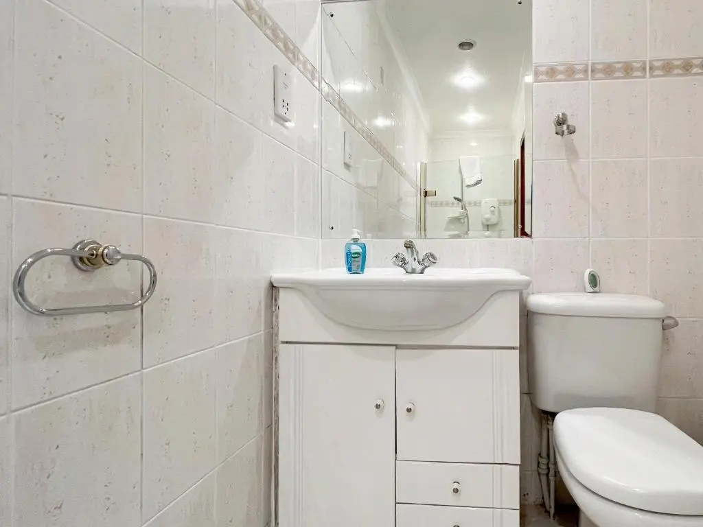 a white bathroom with a toilet and a sink at Oich View - Uk37554 in Kilfinnan
