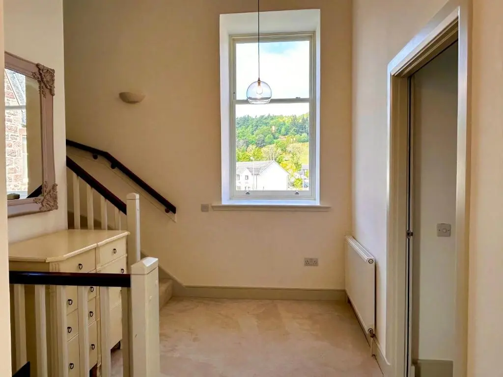 a room with a staircase and a window at 38 Great Glen Townhouse Inverness in Inverness