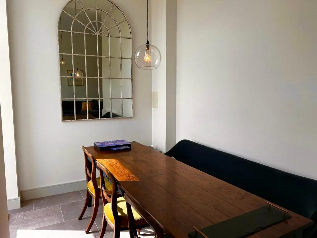 a dining room with a wooden table and chairs at 38 Great Glen Townhouse Inverness in Inverness