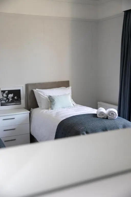 a bedroom with a bed with two towels on it at Whitecraigs in Elgin