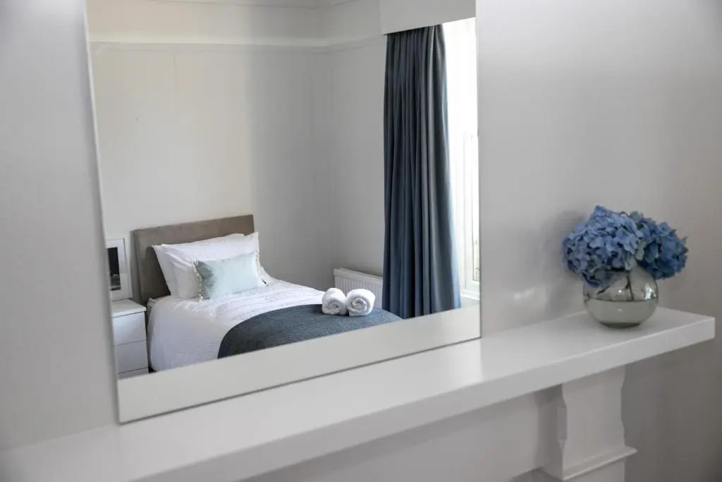 a mirror reflection of a bedroom with a bed at Whitecraigs in Elgin