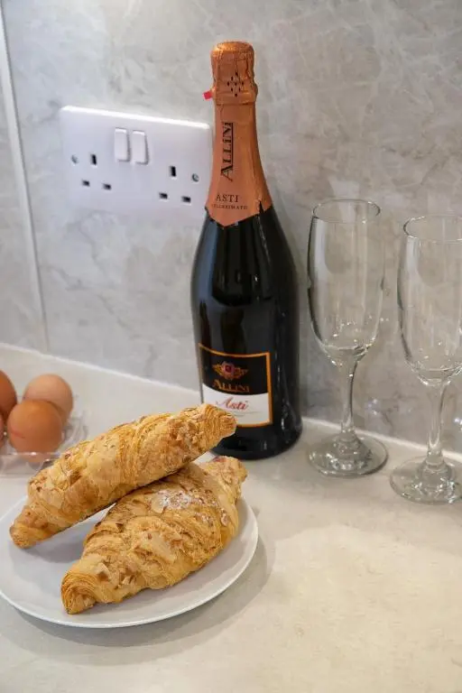 a bottle of wine next to a plate of pastries at Whitecraigs in Elgin
