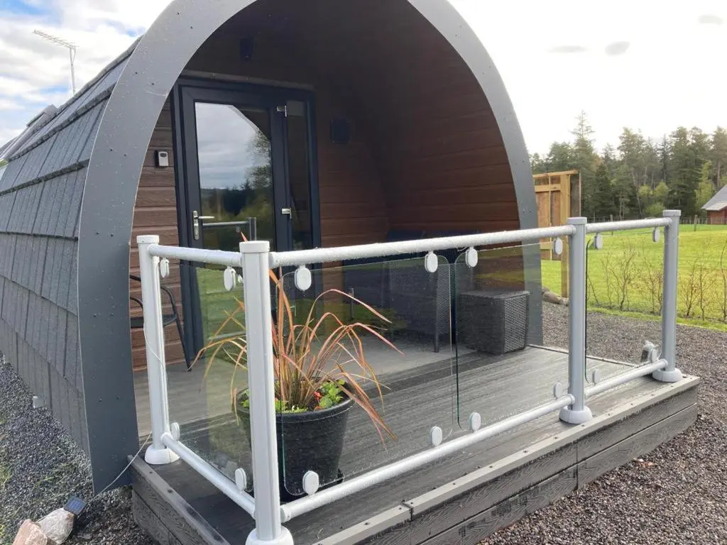 a dome house with a deck with a potted plant at Robins Nest Glamping Pod with Hot Tub in Keith