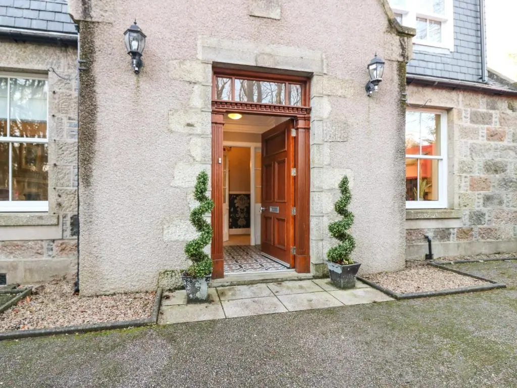 a front door of a house with two potted plants at Mavisbank in Peterhead