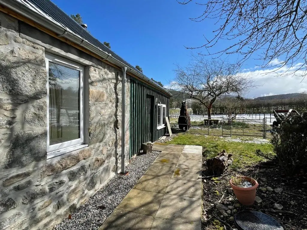 a stone house with a window on the side of it at Farr Out in Farr