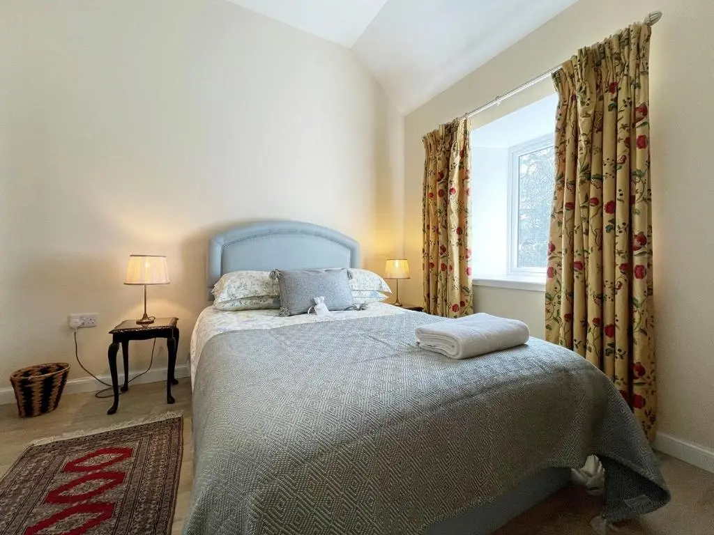 a bedroom with a blue bed and a window at Farr Out in Farr