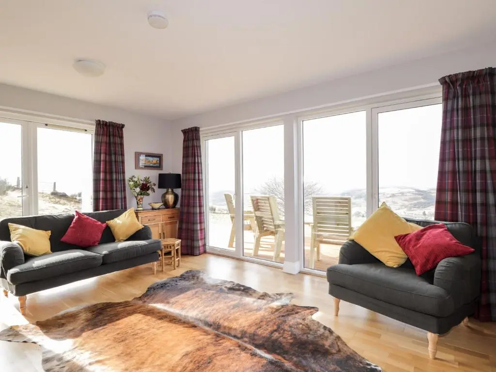 a living room with two couches and a large window at Sealladh Mor in Rogart