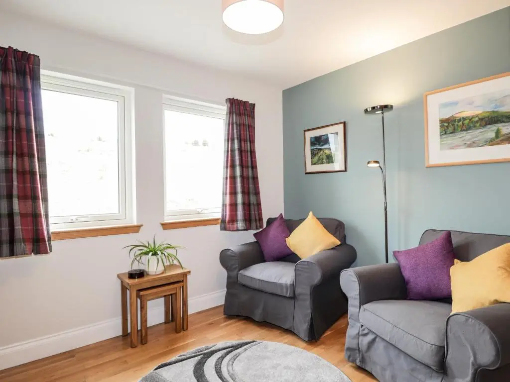 a living room with two chairs and a couch at Sealladh Mor in Rogart