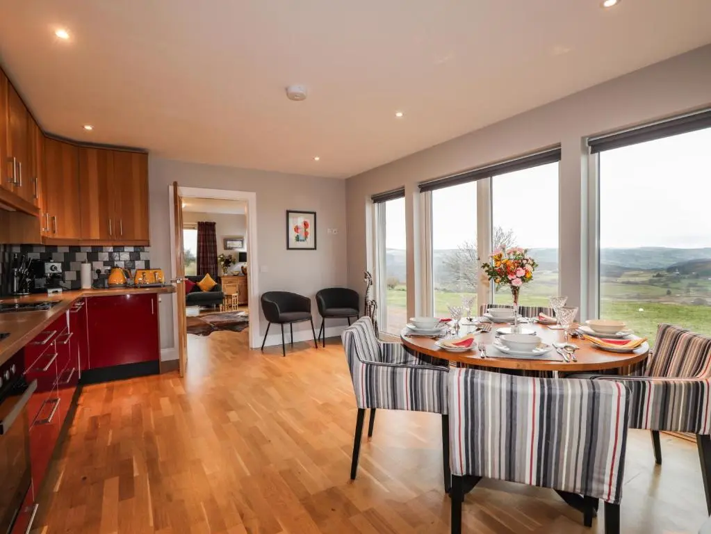 a kitchen and dining room with a table and chairs at Sealladh Mor in Rogart