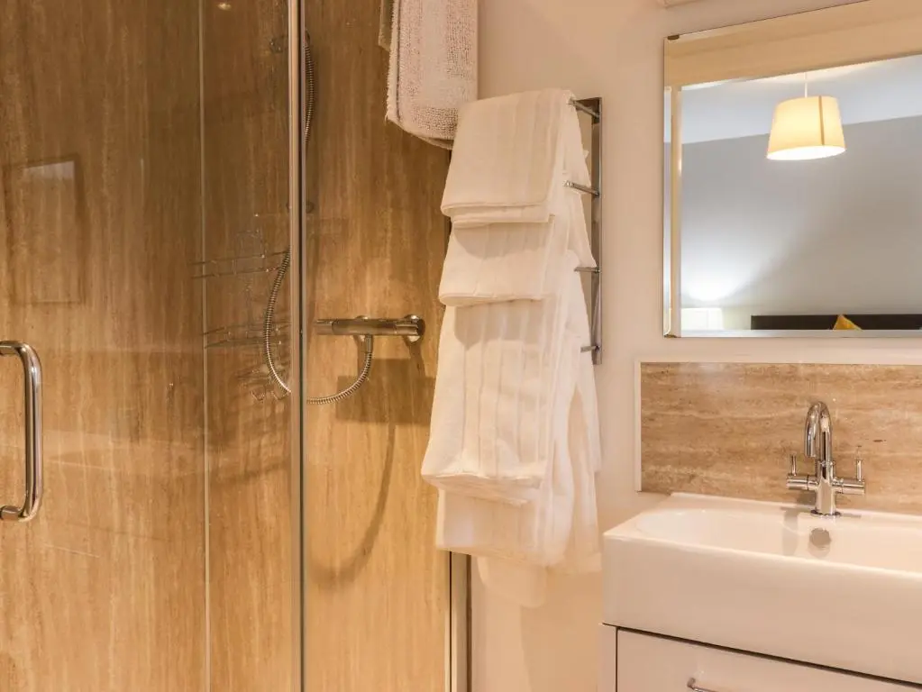 a bathroom with a shower and a sink and a mirror at Sealladh Mor in Rogart