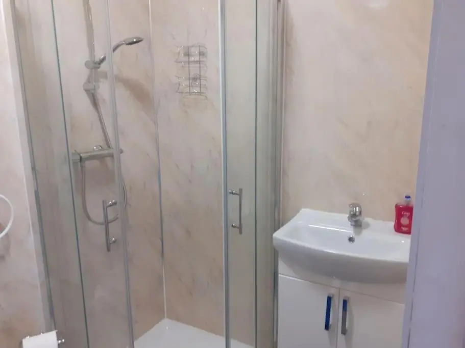 a bathroom with a shower and a sink at Lossiemouth Seaside Flat in Lossiemouth