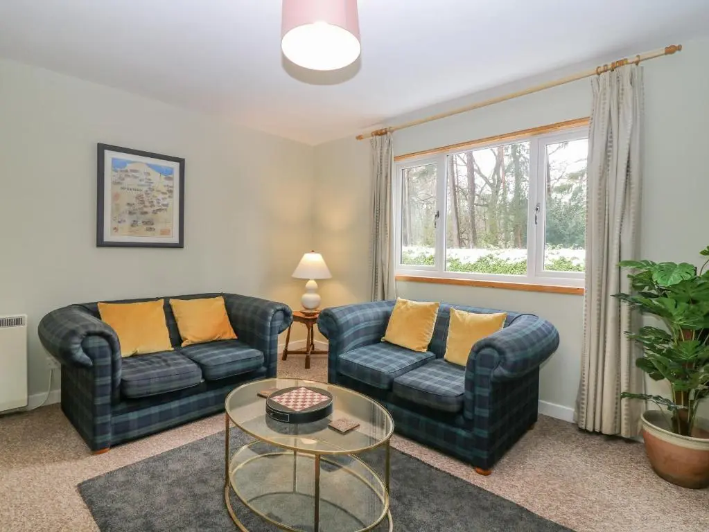 a living room with two couches and a table at The Bungalow in Elgin